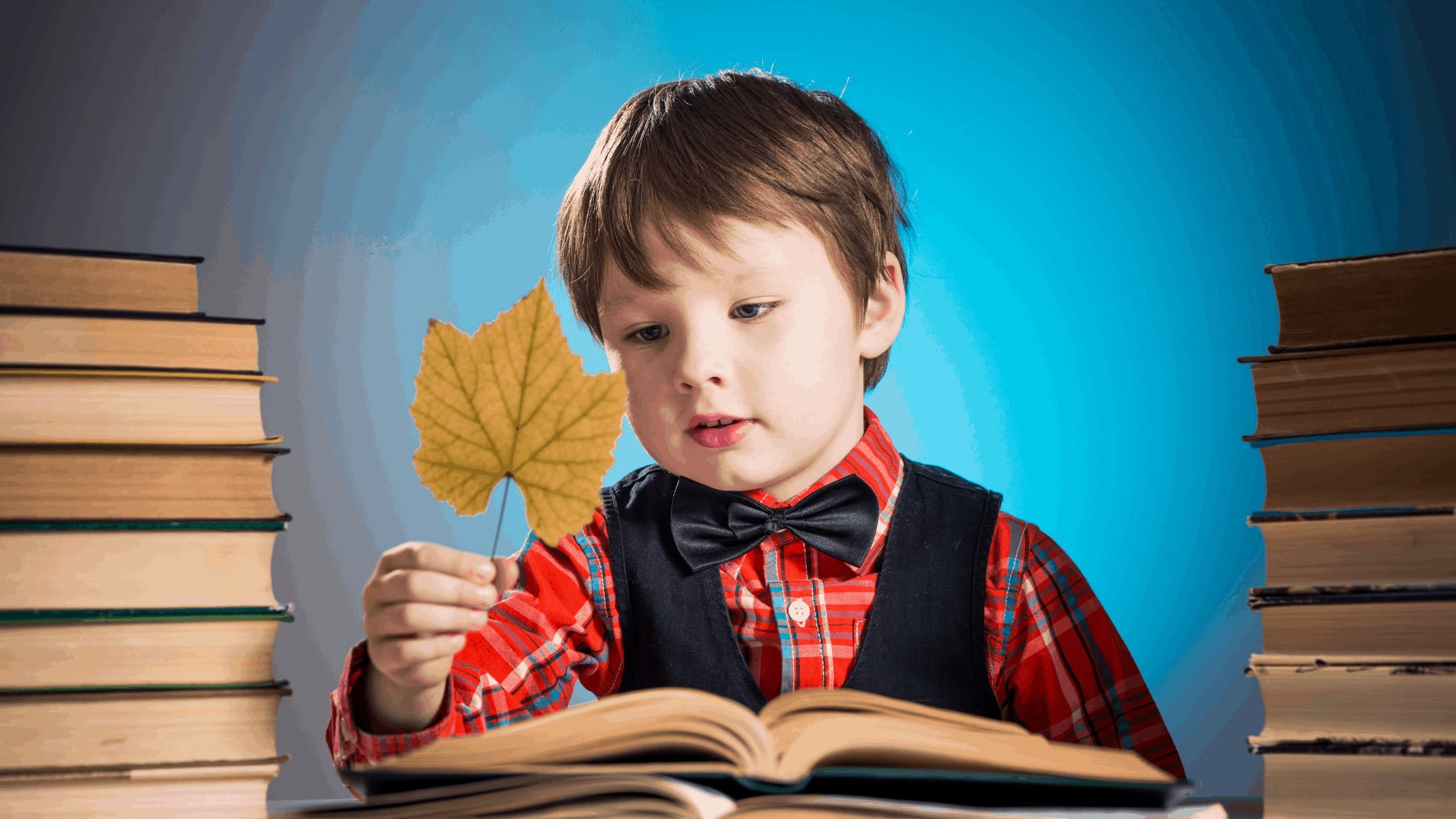 Child with leaf and books